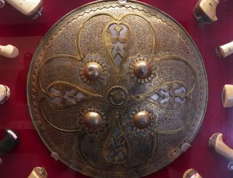 Cross on the center of a shield with four suns